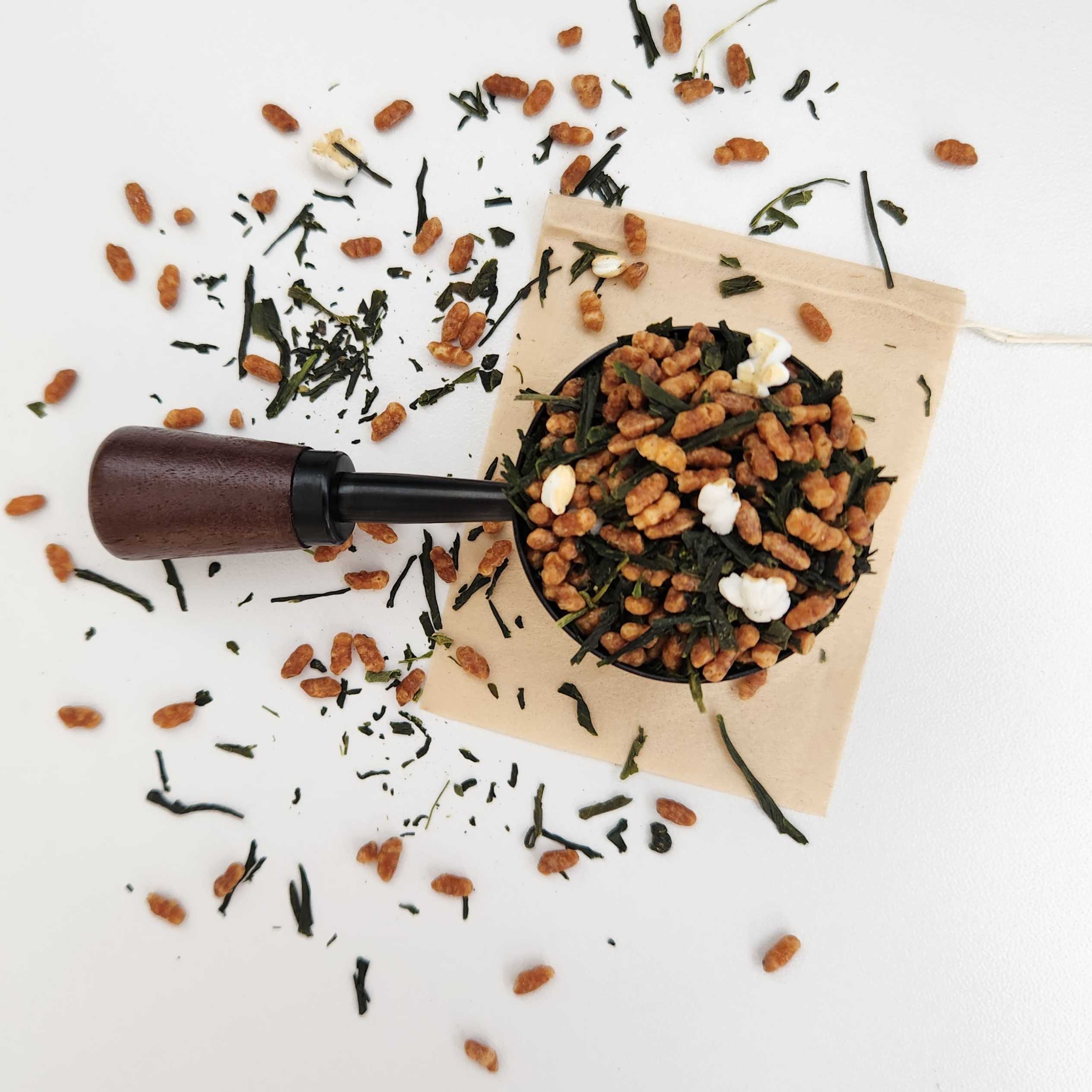 Monimo biodegradable and home compostable eco-friendly teabag pictured with Premium Japanese Genmaicha green tea leaves.