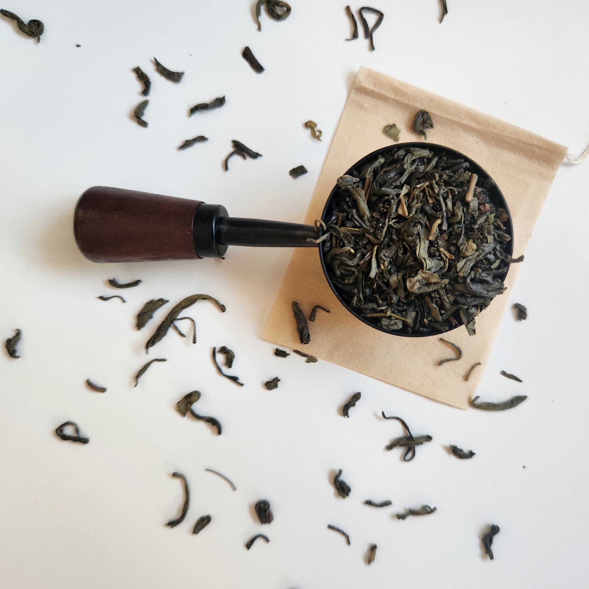 Monimo biodegradable and home compostable eco-friendly teabag pictured with Special Grade Jasmine Green tea.